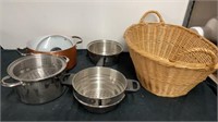 Basket full of pots and pans with kettle and