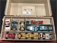 Slot cars and parts in tackle box.