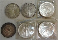 Lot of 5 silver Eagles and 1 silver round
