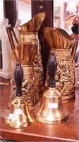 Five brass items: three pitchers with people in