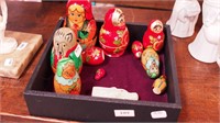 Two sets of nesting dolls, one of animals,