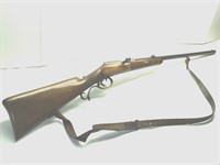 Single shot bolt action rifle with leather strap
