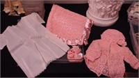Collection of vintage crocheted baby clothes and