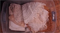 Tub of vintage linens: crocheted doilies,