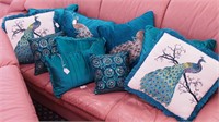 10 decorative pillows, many depicting
