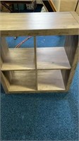 Cubed shelving holds four 30 1/2 inches wide by