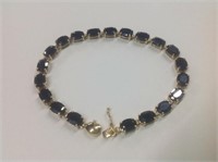 14k yellow gold Sapphire Bracelet features 20 oval
