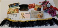 Box of girly items includes hair net, eyeglasses,