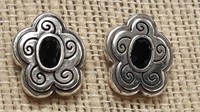 Pair of ornate silver earrings with dark red