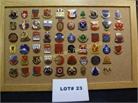 Fifty eight vintage military pins mounted on cork