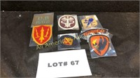Six vintage military patches and a tab