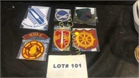 Six military patches and a tab