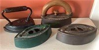 4 antique sad irons - one with the original wood