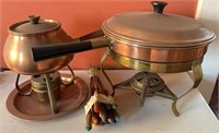 Copper fondue pot with fondue sticks and a copper