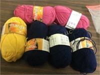 assorted skeins yarn pink blue yellow