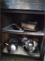 Pot and pans ,tea kettle. Contents of cabinet