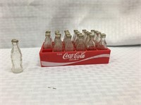 Cola-Cola plastic mini crate and 24 bottles.