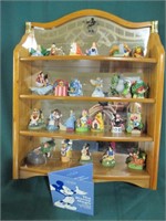 24 Disney characters on wooden display shelf