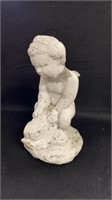 Concrete whitewashed cherub on a fish. 15" high.