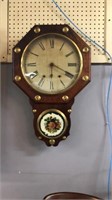 Antique wall clock with key and pendulum