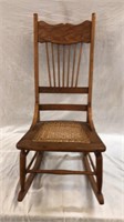 Pressed back sewing rocker with cane seat