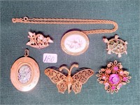 (4) pins; (1) locket: and (1) nceklace