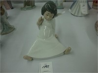 Lladro figurine of a sitting angel.