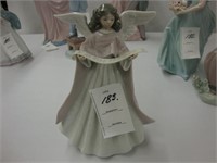 Lladro figure of a angel with a pink cape.