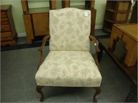 Queen Anne arm chair with floral carving.