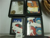 Four small cases containing various badges and