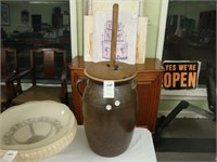 Large brown pottery butter churn with dasher,