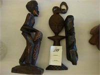 Three carved African tribal figures.