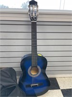 Blue acoustic guitar with guitar bag and
