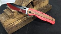 Red plastic/wood handle knife