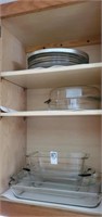 Cabinet of glass casseroles,  loaf pans etc