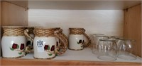 Shelf of apple mugs & small juice glasses