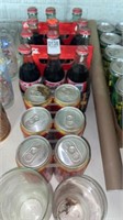 Unopened 6 packs of Coca-Cola cans and bottles