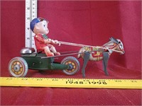 Vintage tin and plastic kid on cart with donkey