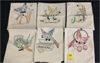 Six embroidered tea towels