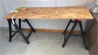 PIECE OF PLYWOOD 67” BY 24 IN AND 2 SAWHORSES