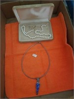 PEARL NECKLACE AND EARRINGS AND A NECKLACE