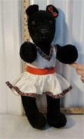 Older jointed teddy bear with handmade clothing