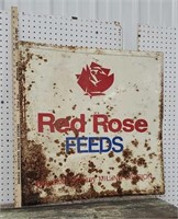 Red rose feeds rusty old sign