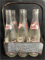 Pepsi bottles and metal carton