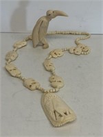 Ivory-type necklace and bird