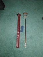 vintage pool cue and golfing chair