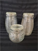 Three glass honeycomb style canisters.