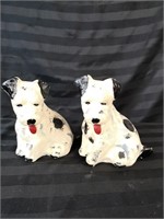Two pottery black and white dog figures.