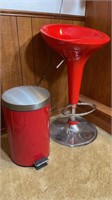 Red stool and trash can