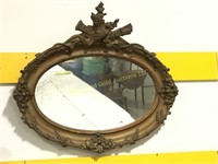 Antique oval ornate mirror